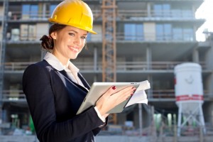 Female construction engineer / architect with a tablet computer at a construction site